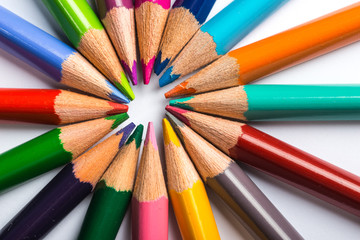 Several color pencils on a white paper sheet