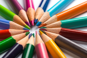 Fototapeta premium Several color pencils on a white paper sheet