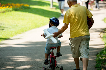 grandfather and child in park using tablet