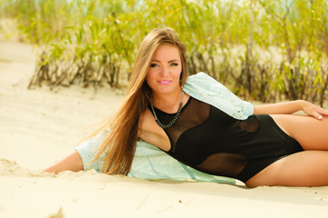 Young woman posing in grassy dune