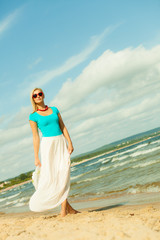 Fototapeta na wymiar Beautiful blonde girl in hat on beach
