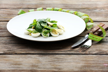 Obraz na płótnie Canvas Salad with quail egg and basil in plate