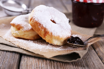 Delicious donuts with icing and powdered sugar