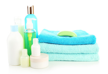 Obraz na płótnie Canvas Stack of towels with shampoo bottles and soap isolated on white