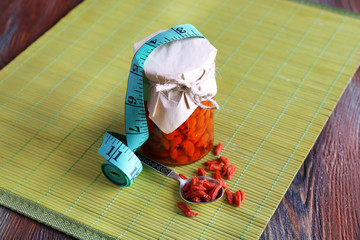 Goji berries in glass bottle wrapped with paper