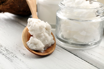 Coconut with jars of coconut oil and cosmetic cream