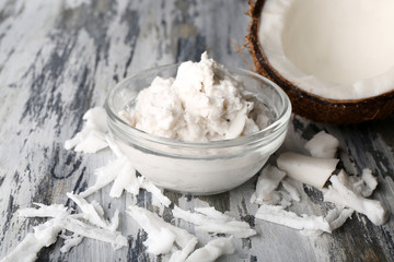 Coconut coconut oil and flakes on wooden background
