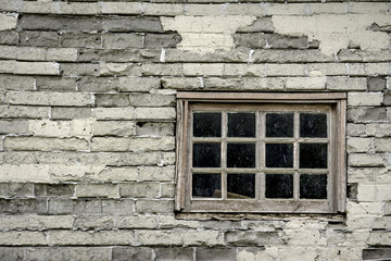 Very old window in the side of a farm house