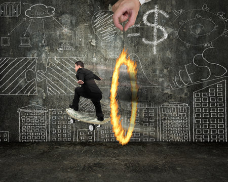 Businessman Skating On Money Skateboard Through Fire Circle With