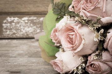 vintage pink rose flower on wooden background