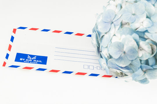 Fototapeta Envelope decorated with light blue hydrangea flowers  isolated o