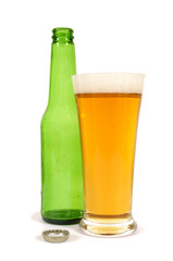 Tall glass of cold beer with empty green bottle isolated on white background photo