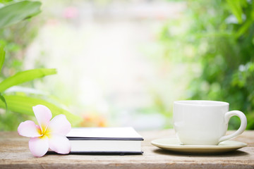 Notebook  and coffee on wooden table