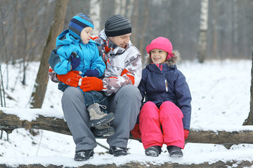 Fototapeta na wymiar Family walking in winter forest