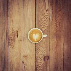 Latte coffee on wood background and texture