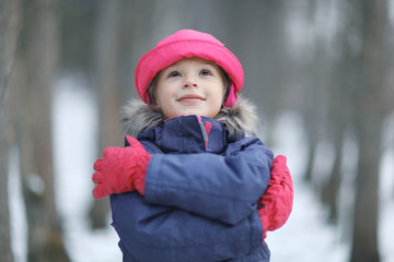 Girl in the park winter snow walk