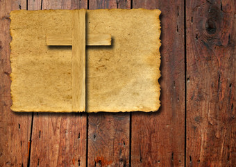 Old vintage Christian paper cross on wood