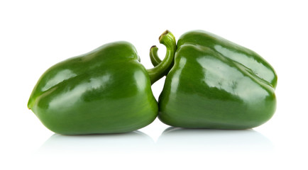 Studio shot of two green bell peppers isolated on white