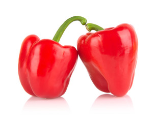 Studio shot of two red bell peppers isolated on white