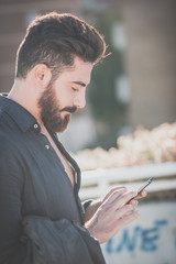 young handsome attractive bearded model man using smartphone