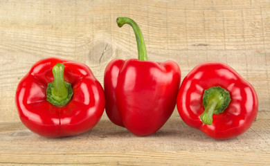 Photo of red bell peppers on wooden table
