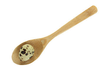quail eggs in a wooden spoon