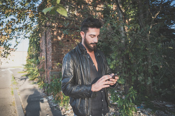 young handsome attractive bearded model man using smartphone