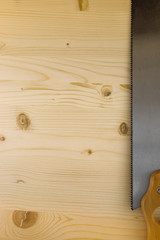 Saw on wooden background