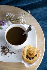 top angle of coffee cup and cinnamon roll