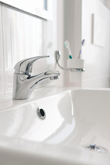 White sink with Steel faucet in a bathroom