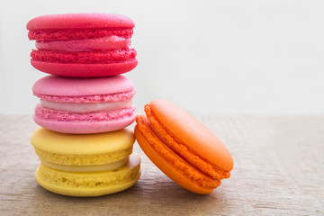 Colorful macaroons stacked on wooden table