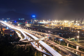 Obraz na płótnie Canvas Illuminated and elevated expressway and cityscape at night