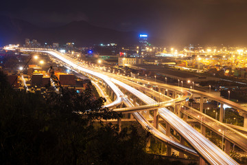 Fototapeta na wymiar Illuminated and elevated expressway and cityscape at night
