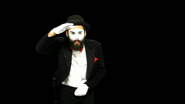 Man mime looks for something and uses binoculars, alpha channel