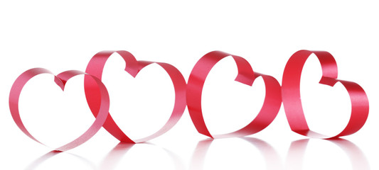 Red ribbons in shape of hearts isolated on white