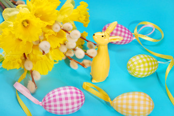 easter decoration with bunch of daffodil  and rabbit figurine