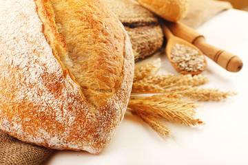 Fresh bread with wheat and wooden spoon of sunflower seeds,