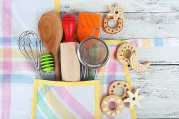 Set of kitchen utensils in pocket of apron, closeup