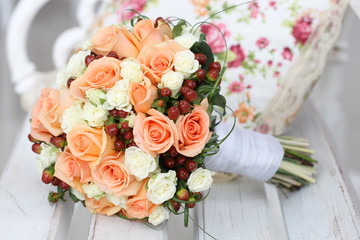 wedding bouquet of roses on a wooden bench