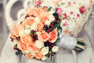 wedding bouquet of roses on a wooden bench
