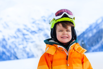 Fototapeta na wymiar Portrait of small boy in ski mask and helmet