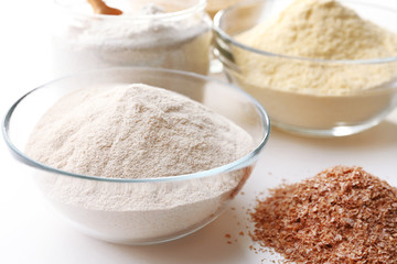 Different types of flour in bowls close up