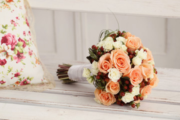 wedding bouquet of roses on a wooden bench