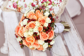 Bouquet of roses on a wooden bench