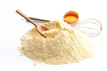 Heap of cornmeal with egg and corolla isolated on white