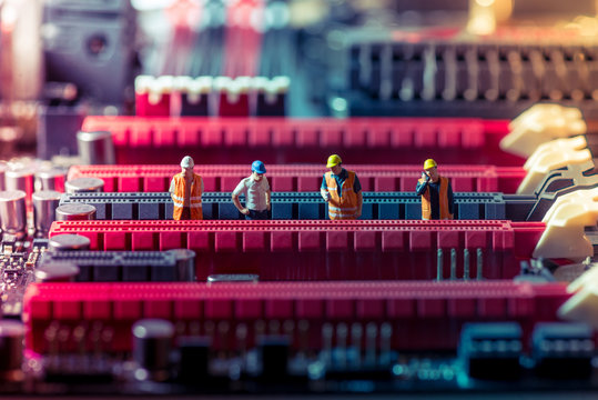 Miniature engineers repairing circuit board. Technology concept - Powered by Adobe