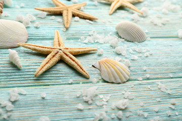 Sea stars and shells on wooden background