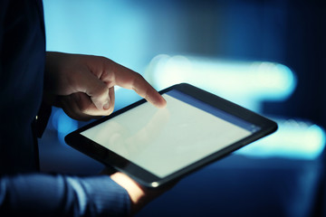 Male hand touching screen tablet close-up
