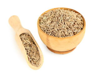 Cumin in wooden bowl, isolated on white
