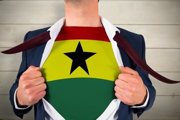 Businessman opening shirt to reveal ghana flag